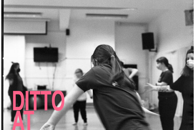 Dancers caught in motion, rehearsing in their studio. Overlaying the black and white image, in the bottom left hand corner, pink text reads DITTO AT NSCD.